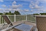 Second story balcony with relaxing lounge chairs